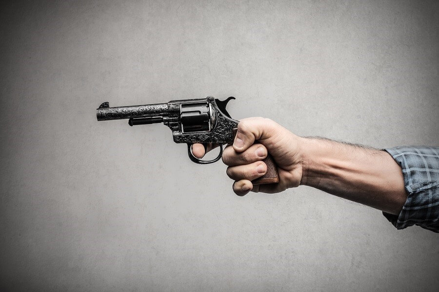 hand holding a revolver pistol gun