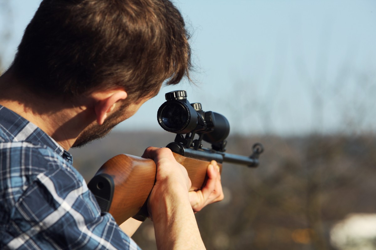 a man using a sniper rifle
